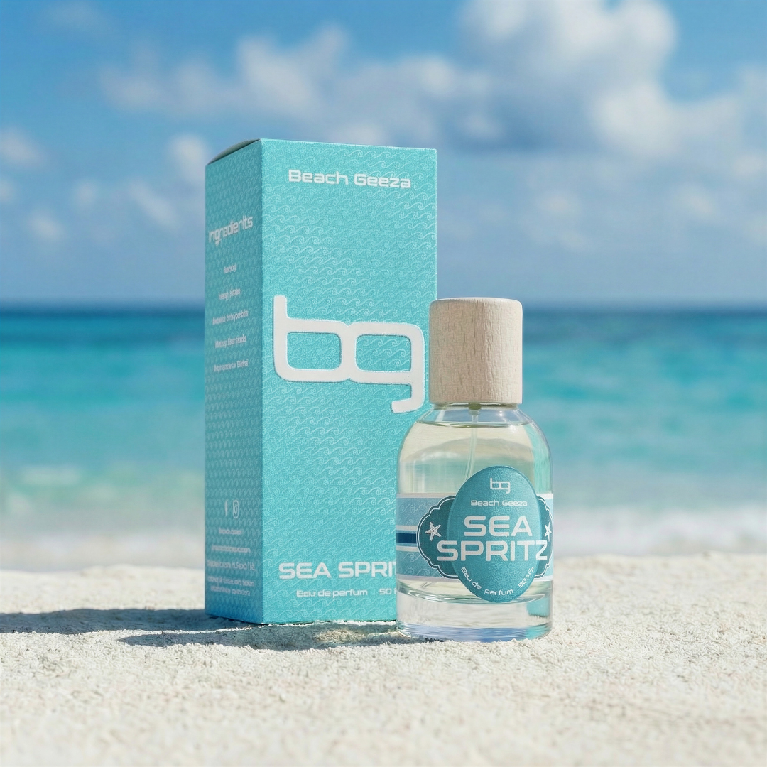 Bottle and box of Beach Geessa Sea Spritz on a sandy beach with ocean and sky in the background